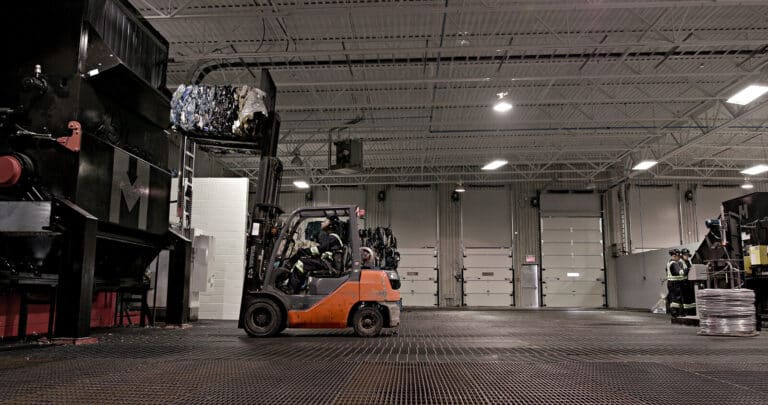 Forklift moving recycling plastic products in a warehouse